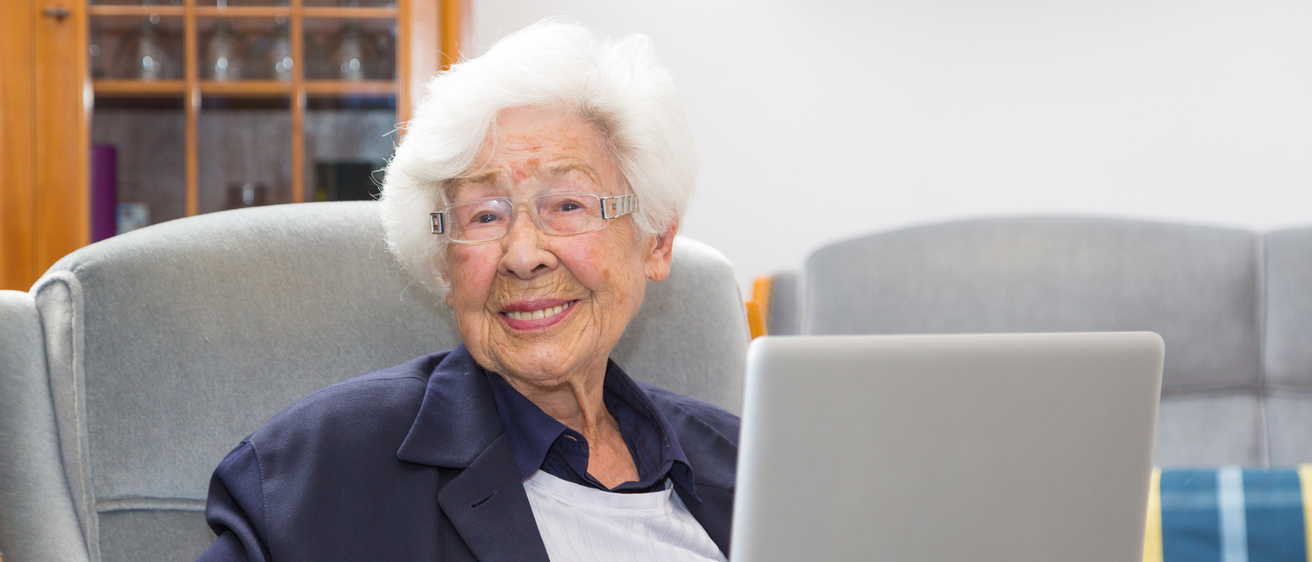Silver-haired woman with laptop computer