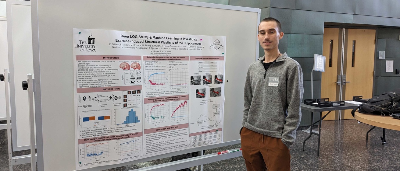 Zak Gilliam with winning poster at 2023 Computational Psychiatry Symposium