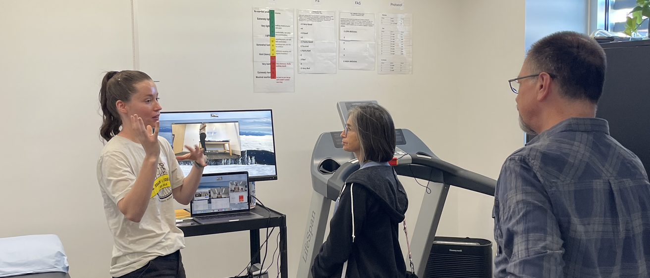 Olivia Hinklin explains exercise techniques to visitors at the HBC Lab open house in November.